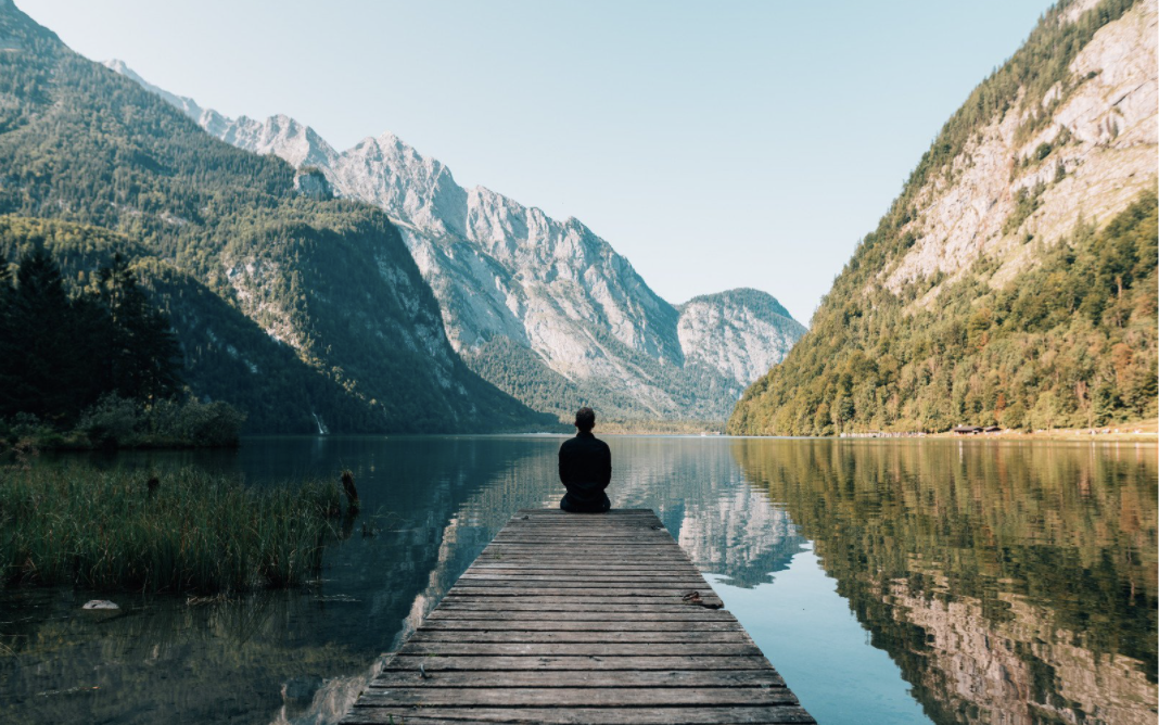 Person on dock in mountains